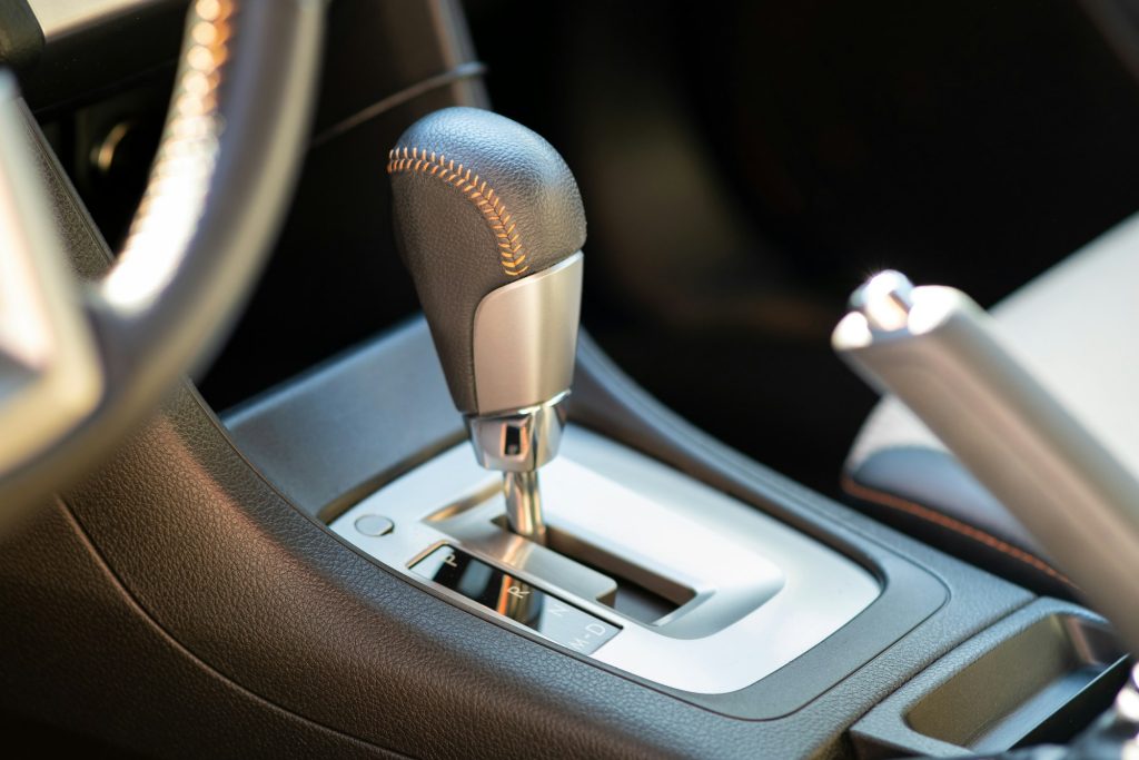 Closeup of car automatic transmission gear stick. Detail of vehicle interior